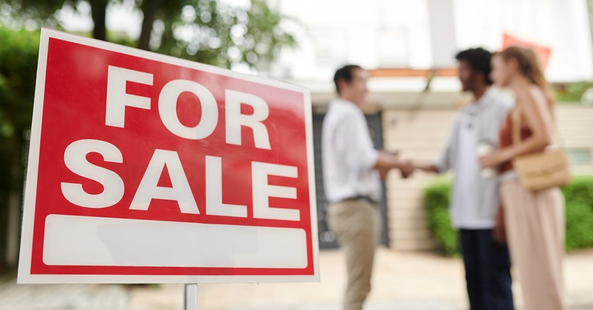 couple greeting real estate agent